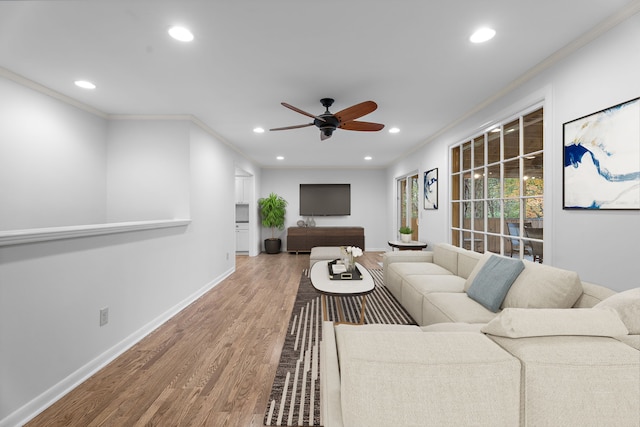 living room featuring crown molding, hardwood / wood-style floors, and ceiling fan