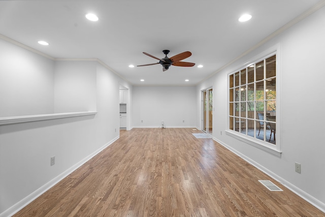 unfurnished living room featuring wood-type flooring, ceiling fan, and ornamental molding