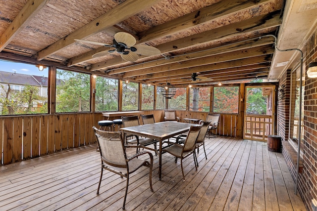 sunroom with beamed ceiling, plenty of natural light, and ceiling fan