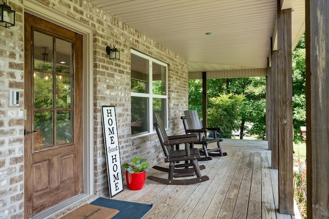 wooden terrace featuring covered porch