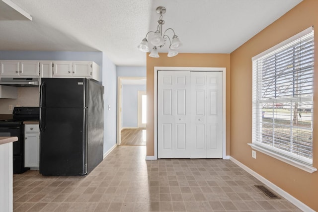 kitchen with white cabinetry, plenty of natural light, black appliances, and decorative light fixtures