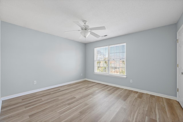 spare room featuring a textured ceiling, light hardwood / wood-style flooring, and ceiling fan