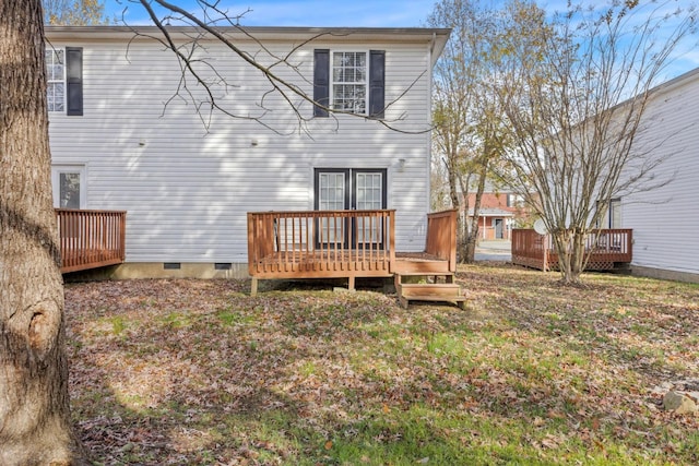 back of house with a wooden deck