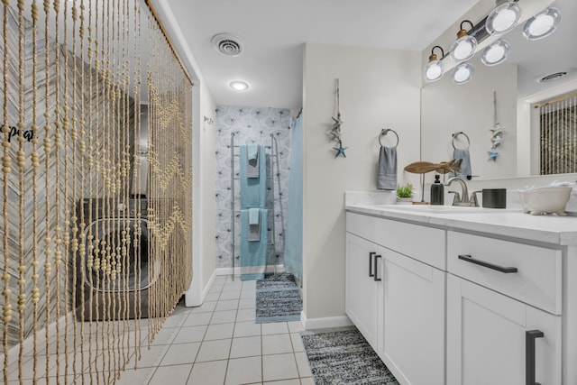 bathroom with tile patterned flooring, vanity, and an enclosed shower