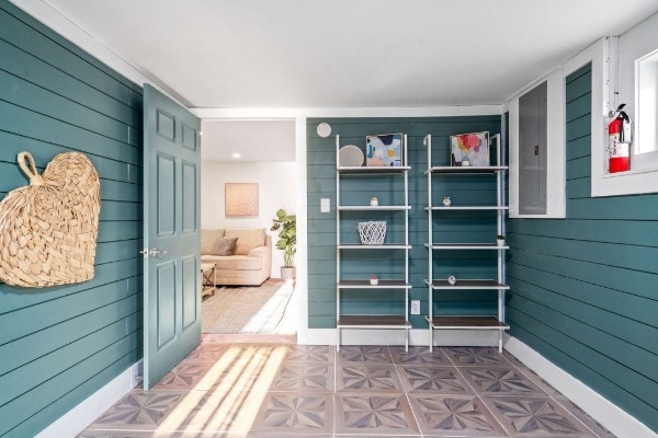 interior space with electric panel and wooden walls