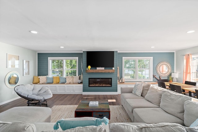 living room featuring a large fireplace and hardwood / wood-style flooring