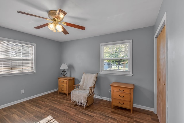 sitting room featuring dark hardwood / wood-style flooring and ceiling fan