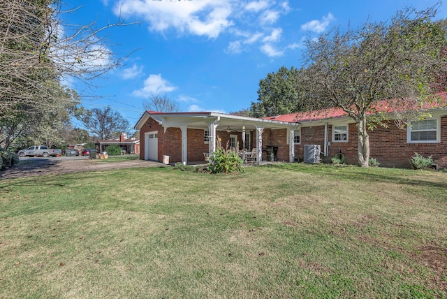 rear view of house with a lawn, a porch, and a garage