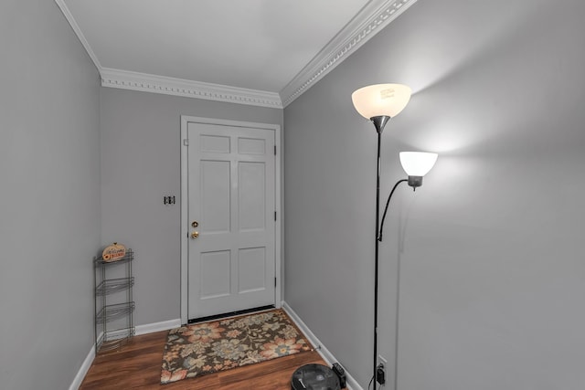 foyer entrance with dark hardwood / wood-style floors and ornamental molding