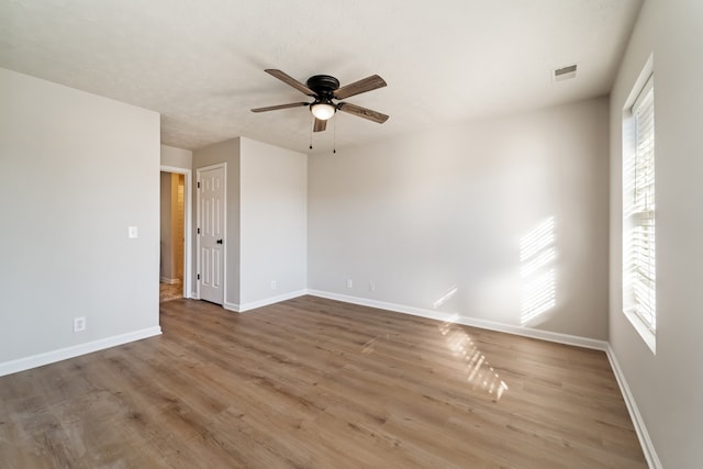 spare room featuring hardwood / wood-style flooring, ceiling fan, and a wealth of natural light