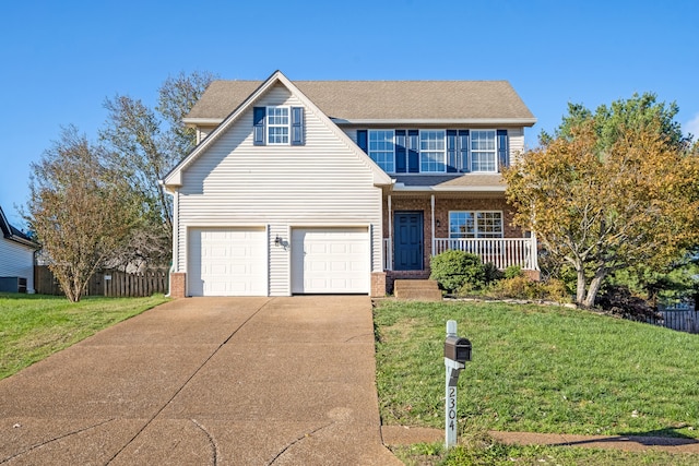 view of front of property with a front yard, a garage, and covered porch