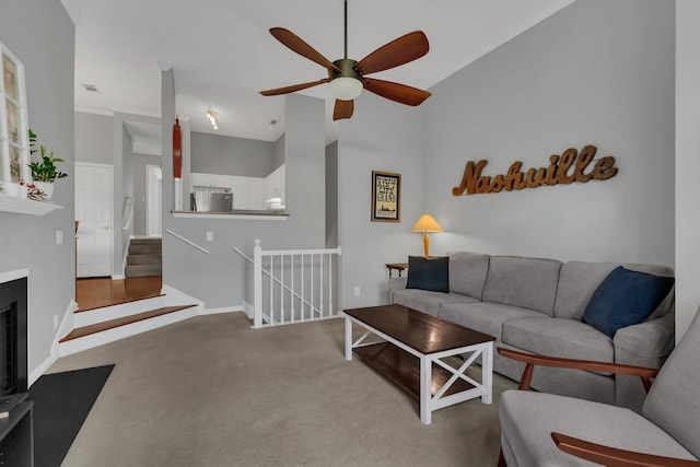 living room with ceiling fan, carpet, and high vaulted ceiling