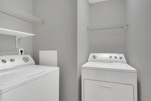 clothes washing area featuring independent washer and dryer