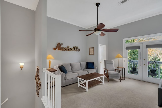 carpeted living room with ceiling fan, ornamental molding, high vaulted ceiling, and french doors