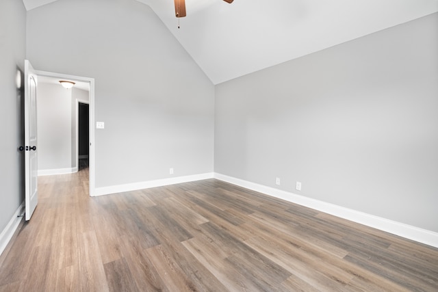 empty room featuring ceiling fan, high vaulted ceiling, and light hardwood / wood-style floors