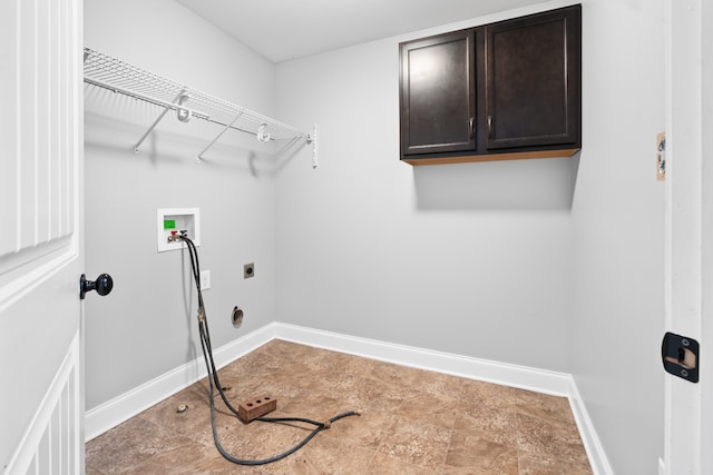 clothes washing area with washer hookup, electric dryer hookup, and cabinets