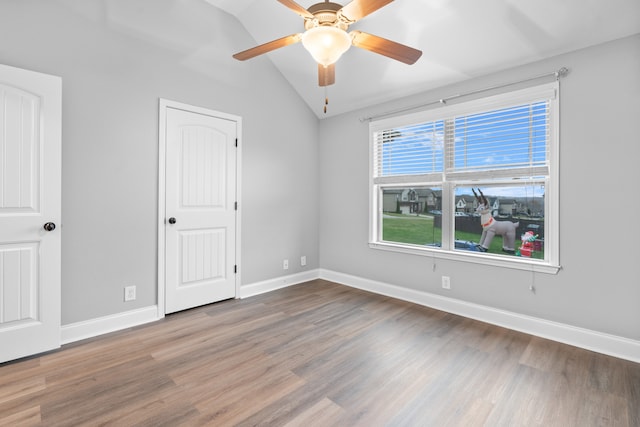 unfurnished room featuring ceiling fan, hardwood / wood-style floors, and vaulted ceiling