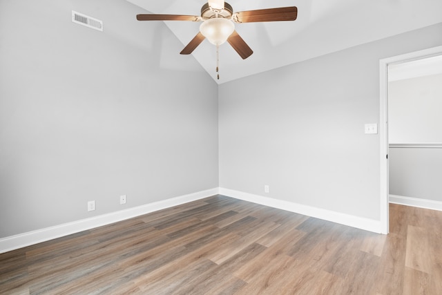 spare room featuring wood-type flooring, ceiling fan, and lofted ceiling