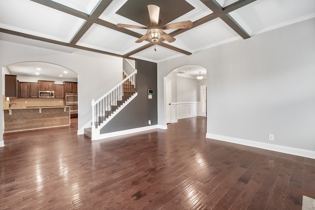 unfurnished living room with beam ceiling, dark wood-type flooring, and coffered ceiling