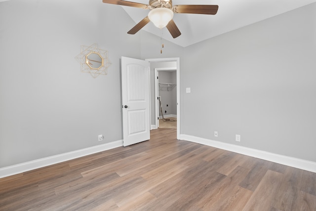 spare room with ceiling fan, light hardwood / wood-style floors, and high vaulted ceiling