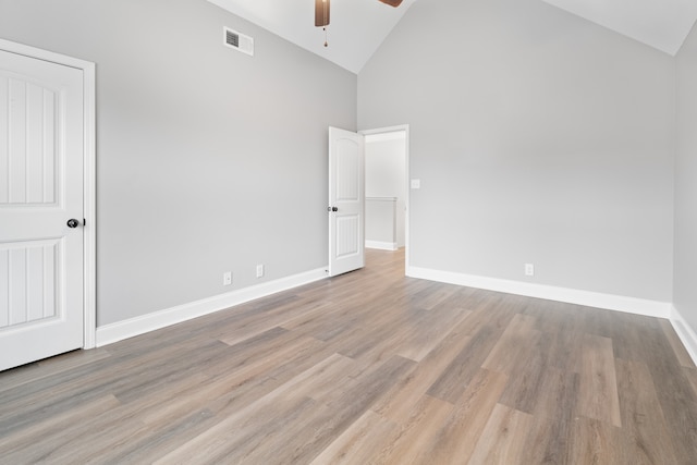 unfurnished bedroom featuring ceiling fan, light wood-type flooring, and high vaulted ceiling