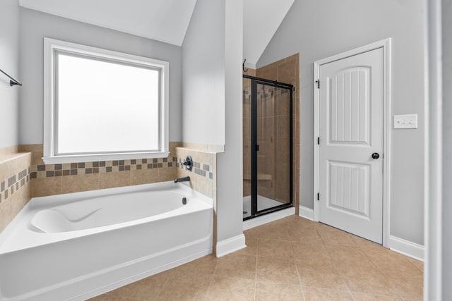 bathroom with tile patterned floors, separate shower and tub, and lofted ceiling