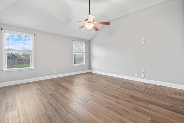 unfurnished room featuring a wealth of natural light, hardwood / wood-style floors, and lofted ceiling