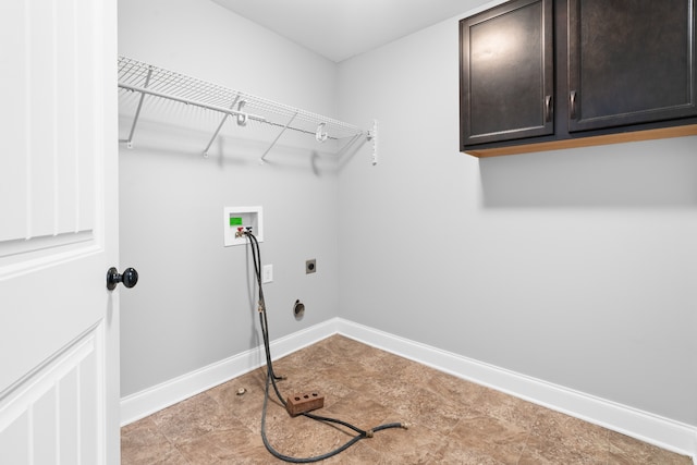 washroom featuring electric dryer hookup, hookup for a washing machine, light tile patterned floors, and cabinets