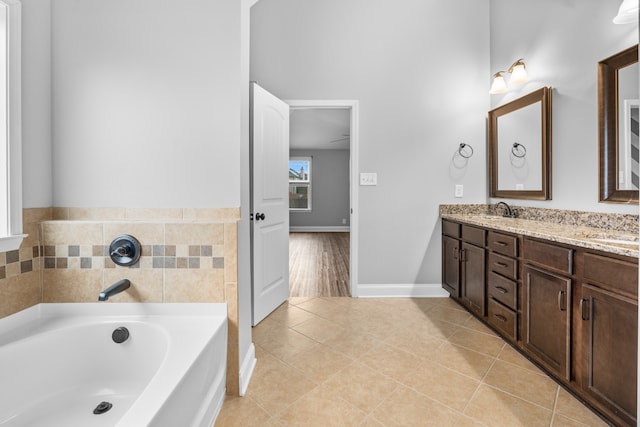 bathroom with vanity, a tub to relax in, and tile patterned floors