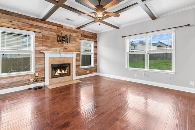 unfurnished living room with wooden walls, ceiling fan, and hardwood / wood-style flooring