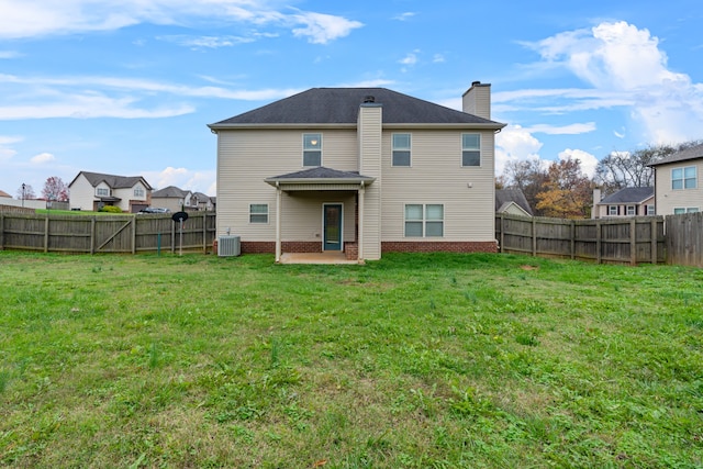 rear view of house with a yard, central AC unit, and a patio area