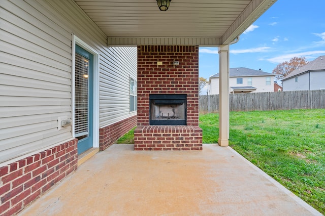 view of patio with an outdoor brick fireplace