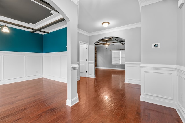 interior space with ceiling fan, coffered ceiling, dark hardwood / wood-style floors, and ornamental molding