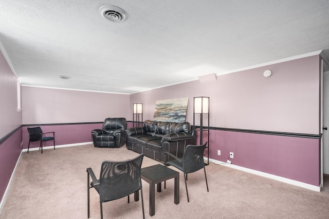 cinema room featuring carpet flooring, a textured ceiling, and ornamental molding