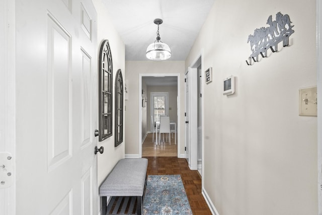 corridor featuring a notable chandelier