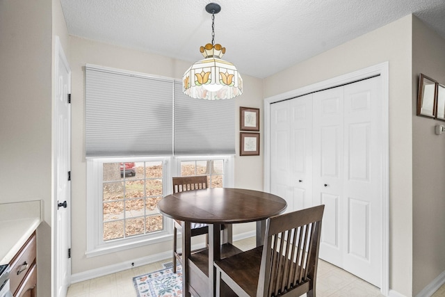 dining area featuring a textured ceiling