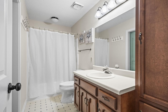 full bathroom featuring shower / tub combo, vanity, a textured ceiling, and toilet