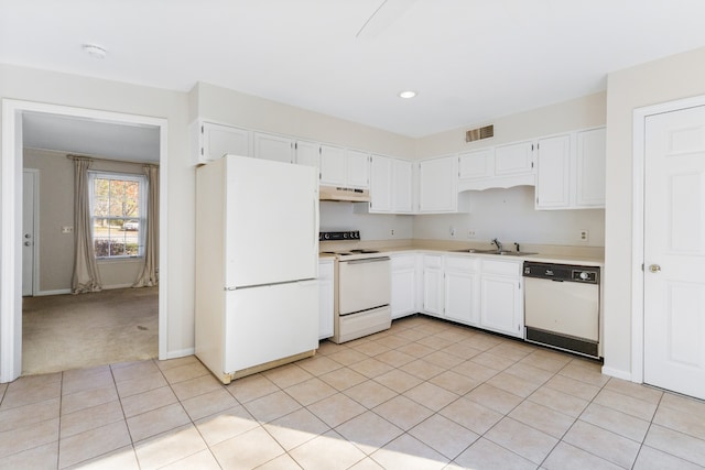 kitchen with white cabinets, light colored carpet, white appliances, and sink