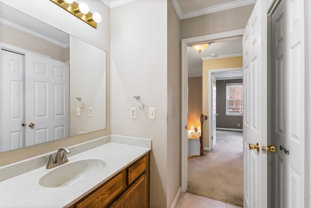 bathroom with crown molding, tile patterned flooring, and vanity