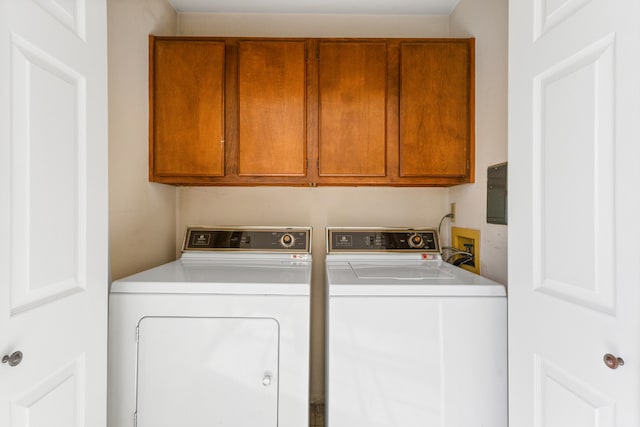 laundry area with washer and clothes dryer and cabinets