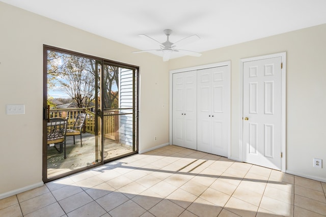 interior space featuring ceiling fan, light tile patterned floors, and access to outside