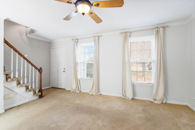 entrance foyer with light colored carpet, plenty of natural light, crown molding, and ceiling fan