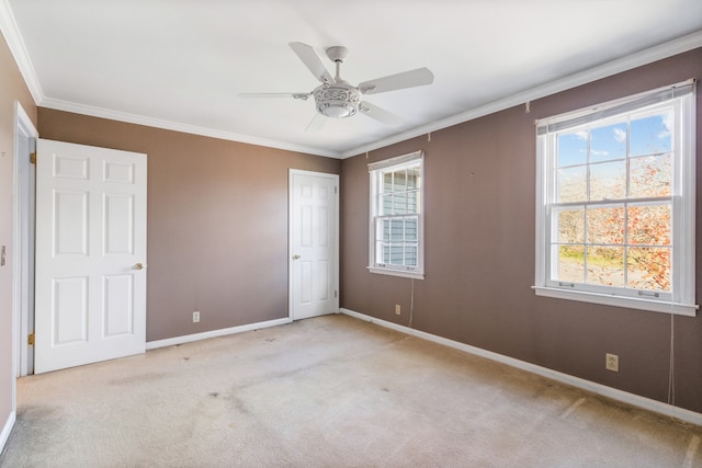 unfurnished bedroom with ceiling fan, ornamental molding, and light carpet