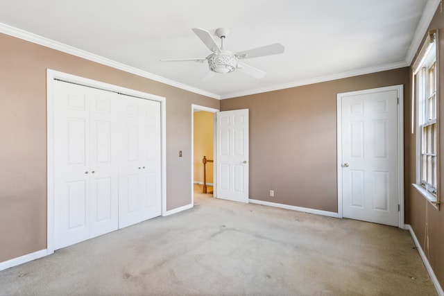 unfurnished bedroom featuring a closet, ceiling fan, crown molding, and light colored carpet