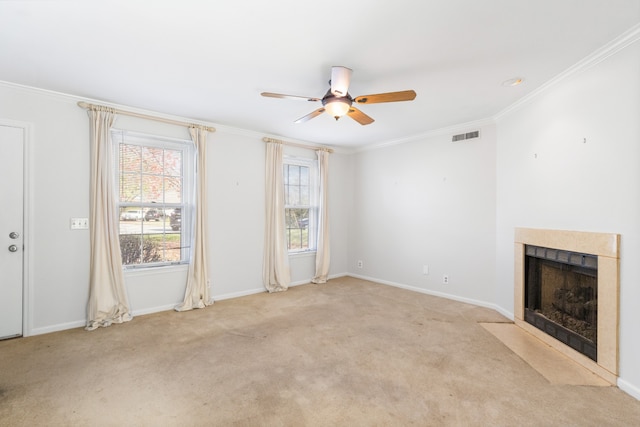 unfurnished living room featuring crown molding, ceiling fan, and light carpet