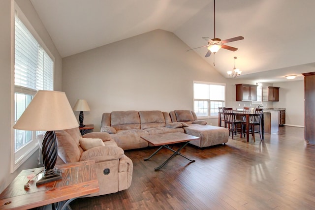 living room with dark hardwood / wood-style flooring, lofted ceiling, and ceiling fan with notable chandelier