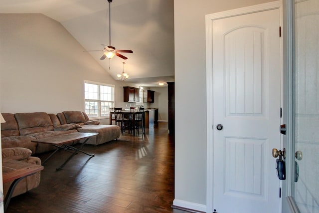 living room with lofted ceiling, ceiling fan, and dark wood-type flooring