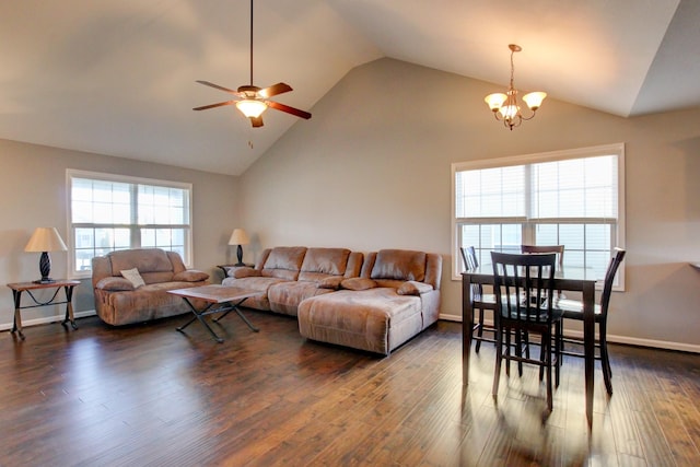 living room featuring dark hardwood / wood-style flooring, lofted ceiling, and ceiling fan with notable chandelier