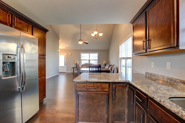 kitchen featuring kitchen peninsula, stainless steel refrigerator with ice dispenser, dark wood-type flooring, vaulted ceiling, and ceiling fan with notable chandelier