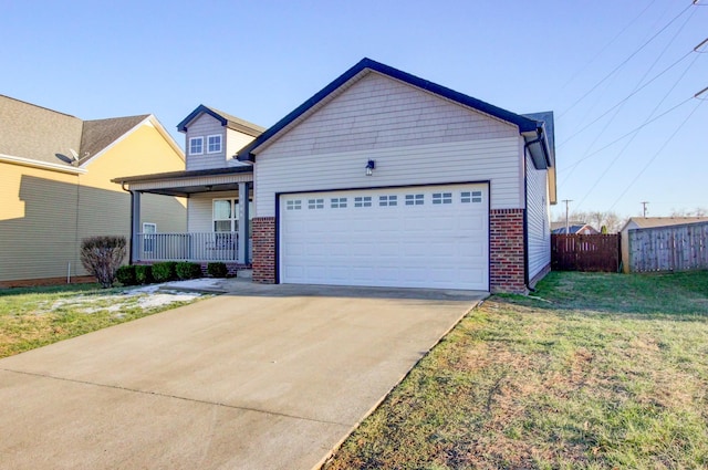 view of front of home featuring a front yard, a garage, and a porch